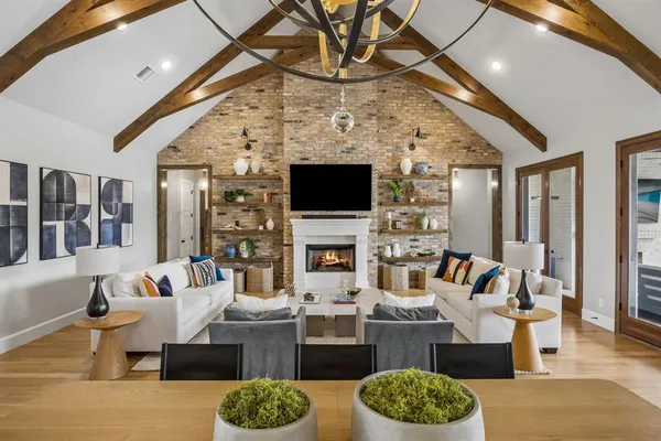 a view of a dining room with furniture a chandelier and wooden floor