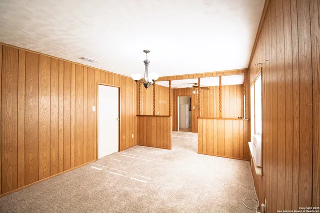 a view of a room with a window and stairs