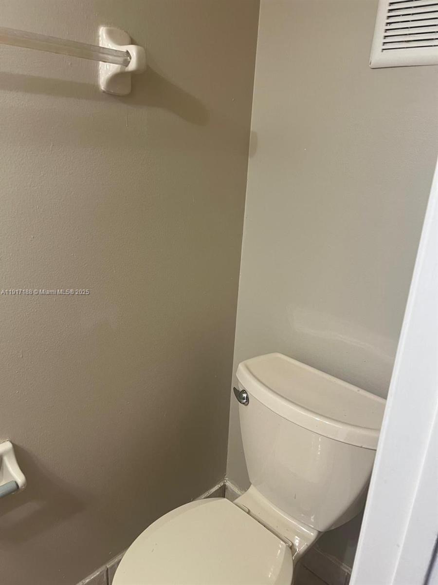 5306 West 26th Avenue, Unit 102 Hialeah, FL 33016 - Photo 11 of 33 a white toilet sitting next to a shower