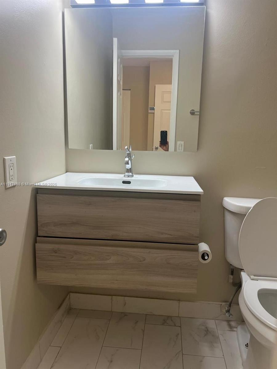 5306 West 26th Avenue, Unit 102 Hialeah, FL 33016 - Photo 14 of 33 a bathroom with a sink and a toilet