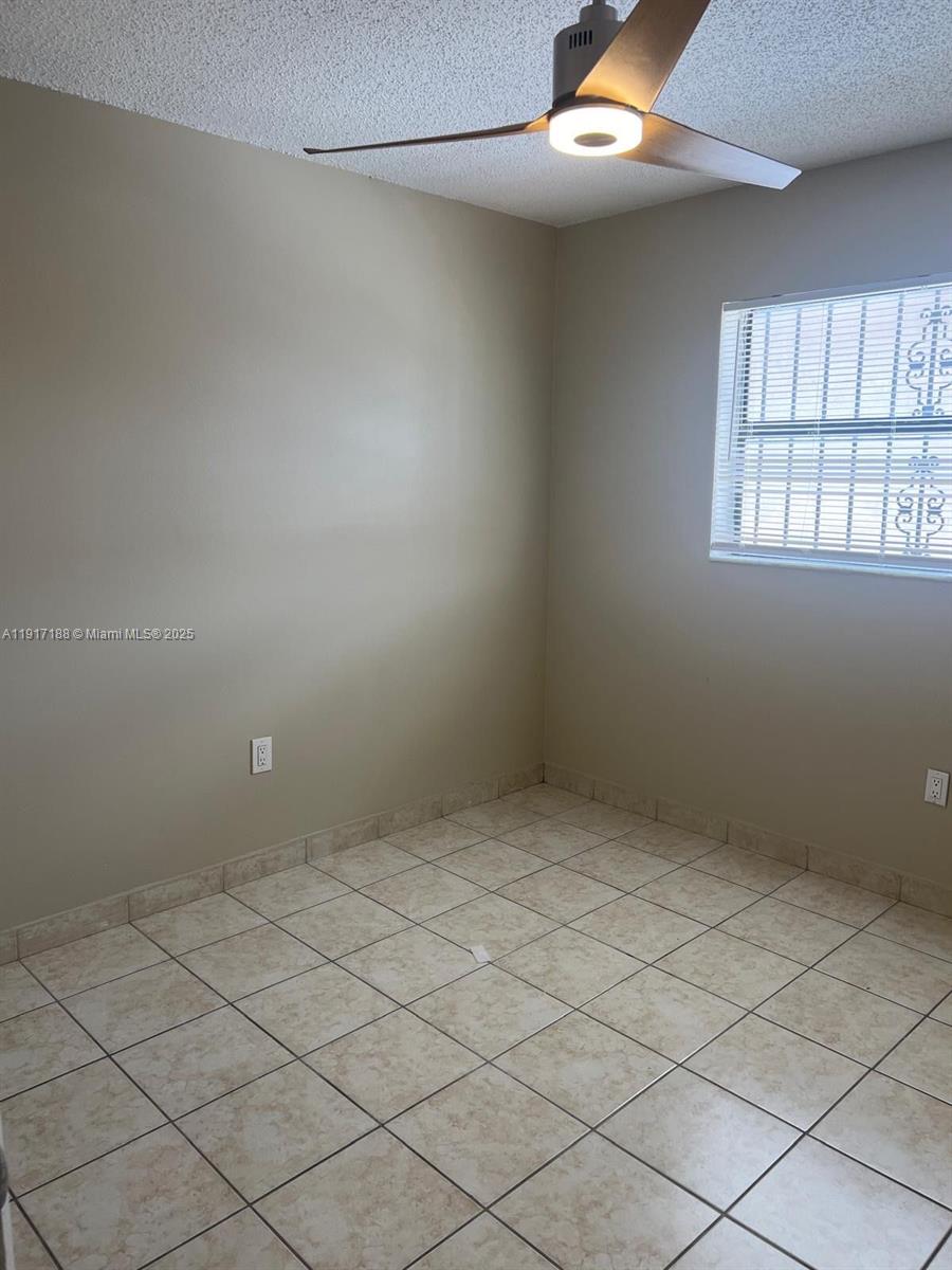 5306 West 26th Avenue, Unit 102 Hialeah, FL 33016 - Photo 20 of 33 an empty room with windows