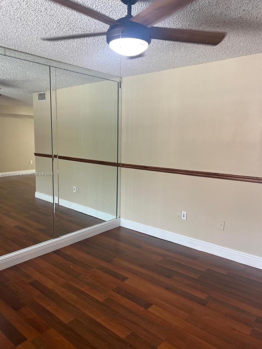 5306 West 26th Avenue, Unit 102 Hialeah, FL 33016 - Photo 23 of 33 a view of a room with wooden floor