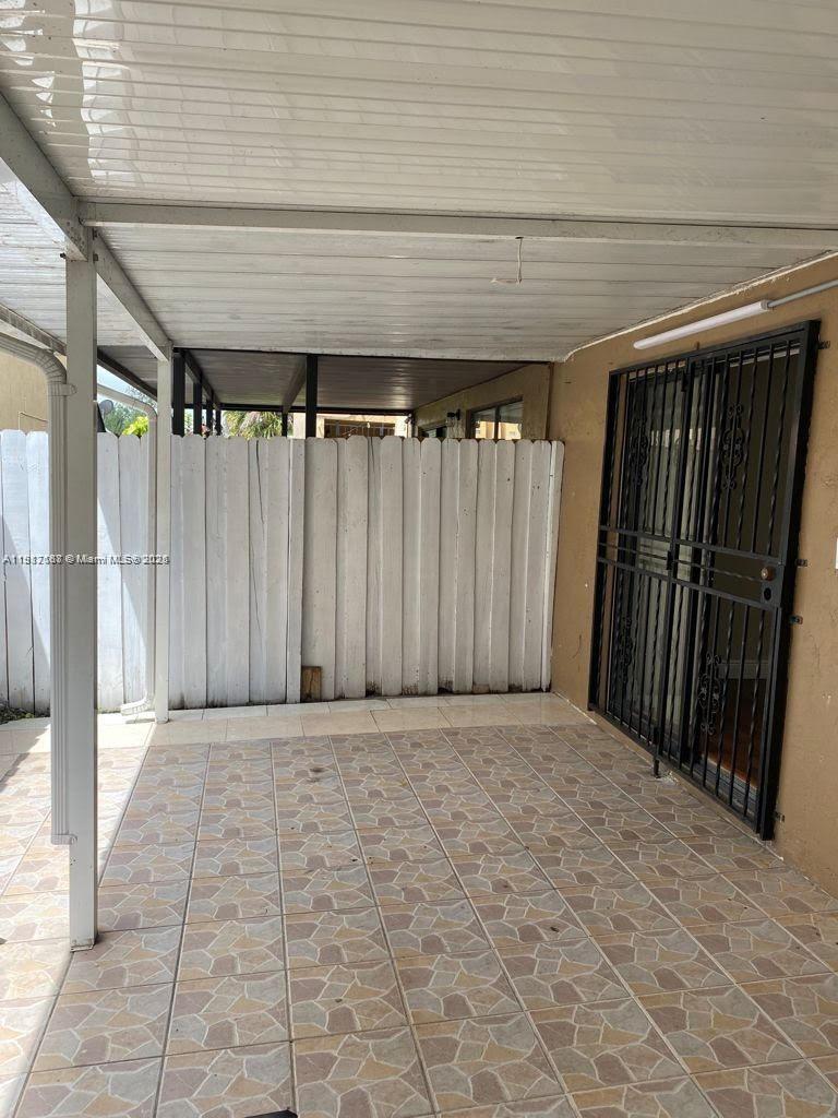 5306 West 26th Avenue, Unit 102 Hialeah, FL 33016 - Photo 29 of 33 a view of a room with wooden walls