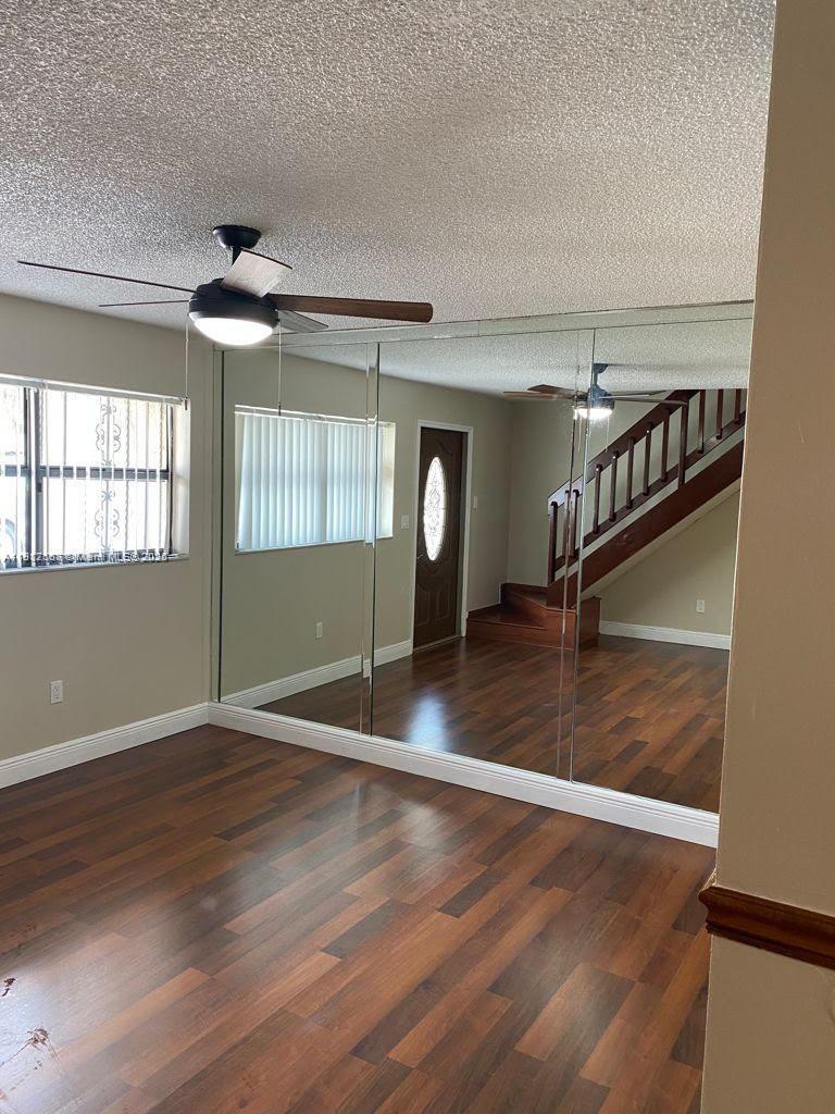 5306 West 26th Avenue, Unit 102 Hialeah, FL 33016 - Photo 32 of 33 wooden floor in an empty room with a window