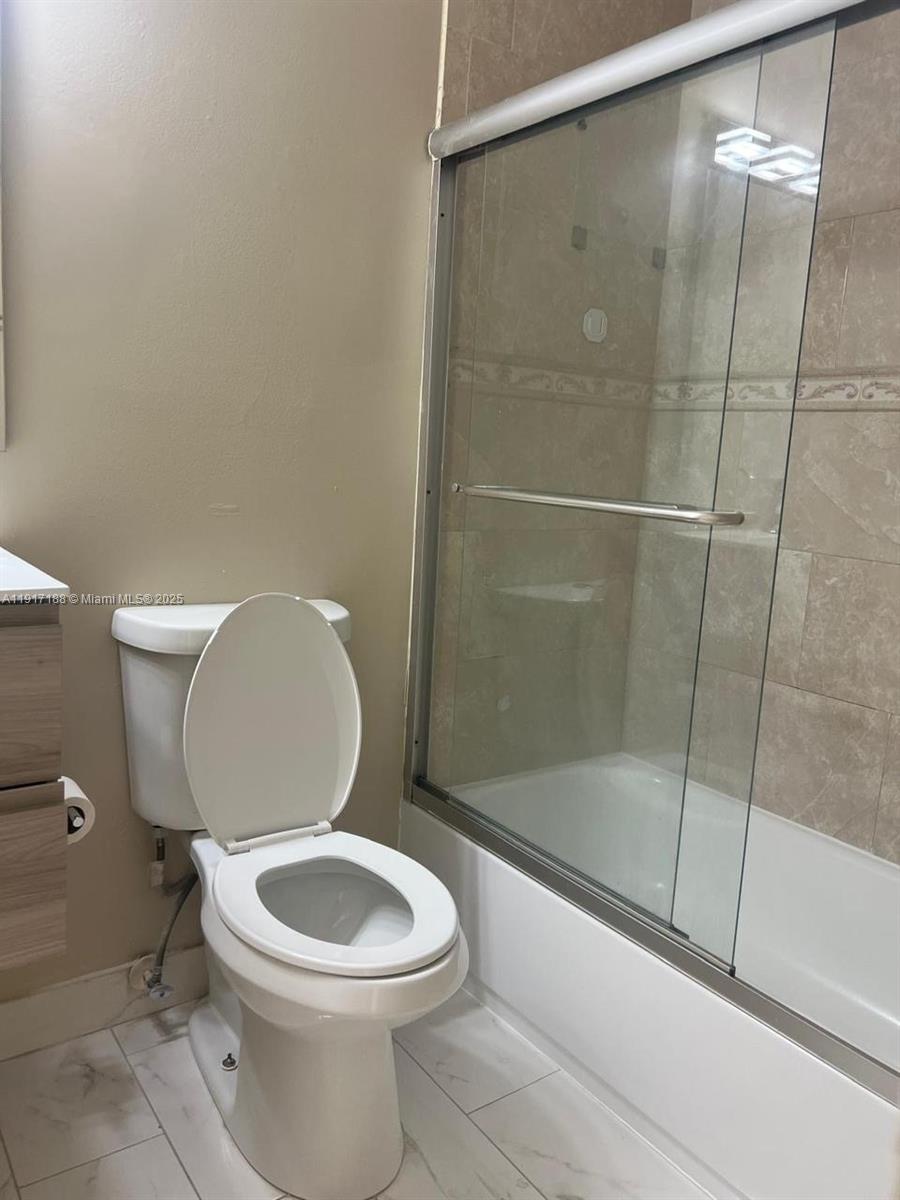 5306 West 26th Avenue, Unit 102 Hialeah, FL 33016 - Photo 5 of 33 a white toilet sitting next to a bath tub and shower
