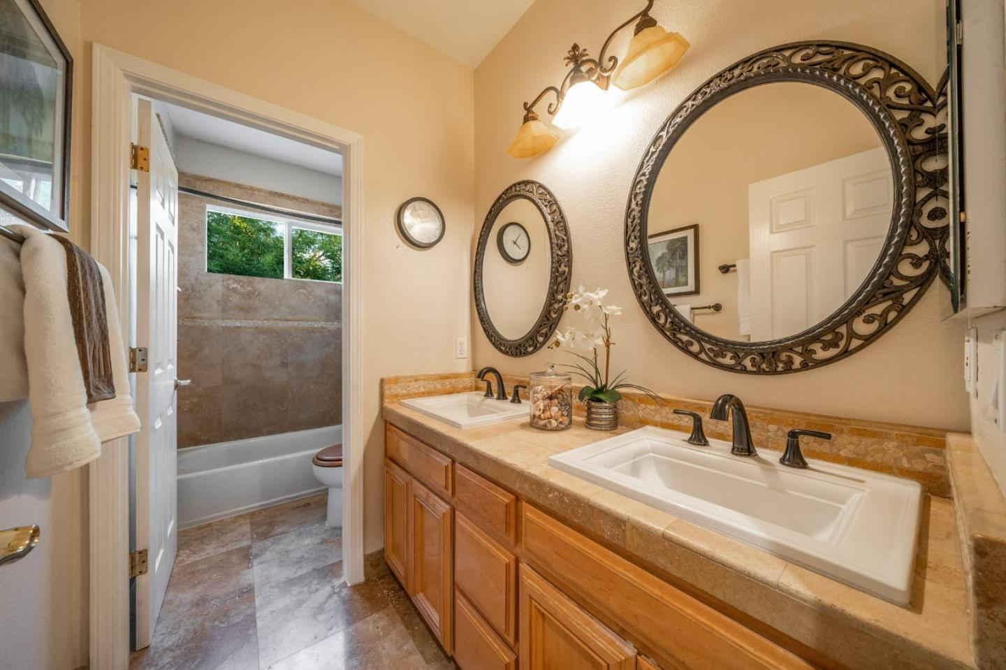 1486 Bay Tree Drive Gilroy, CA 95020 - Photo 18 of 26 a bathroom with a sink and a mirror