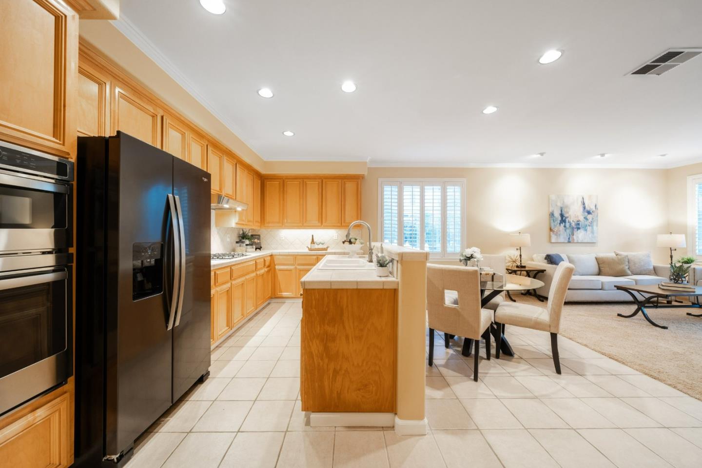 1486 Bay Tree Drive Gilroy, CA 95020 - Photo 9 of 26 a kitchen with stainless steel appliances kitchen island granite countertop a refrigerator and a stove