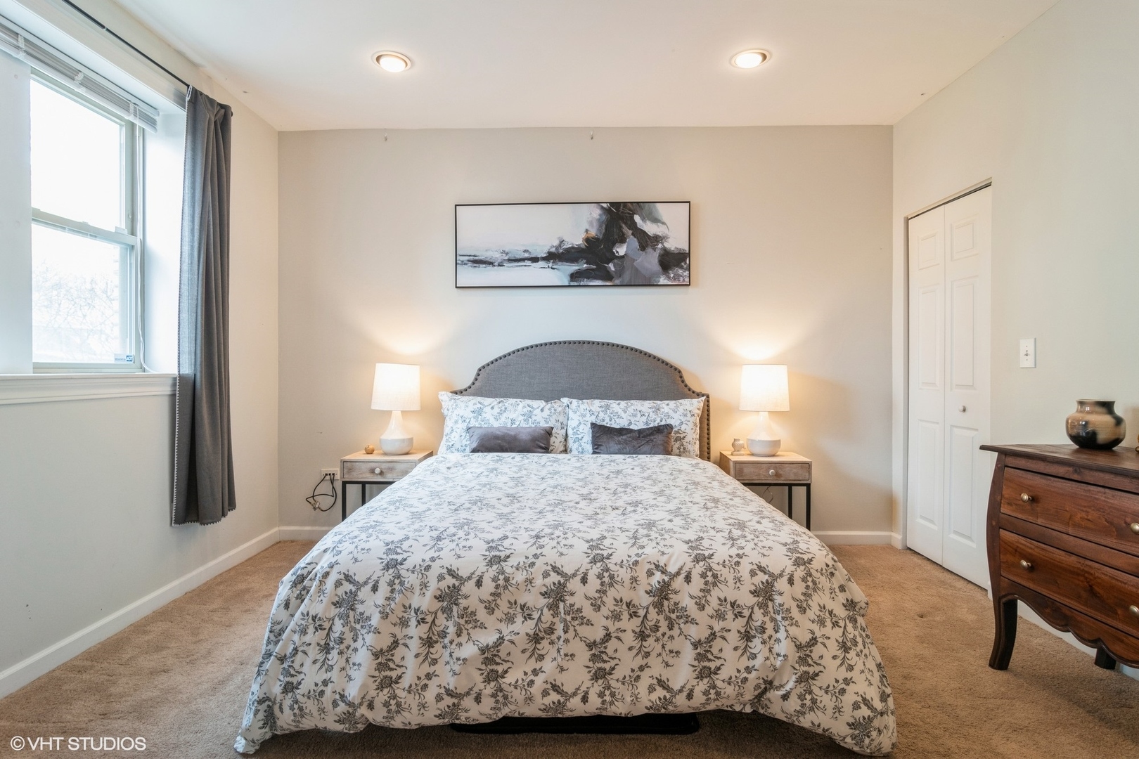 3105 West George Street, Unit 1 Chicago, IL 60618 - Photo 7 of 11 a bedroom with a bed and dresser with mirror
