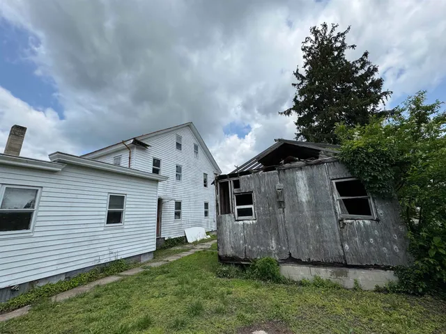 a view of a house with a back yard
