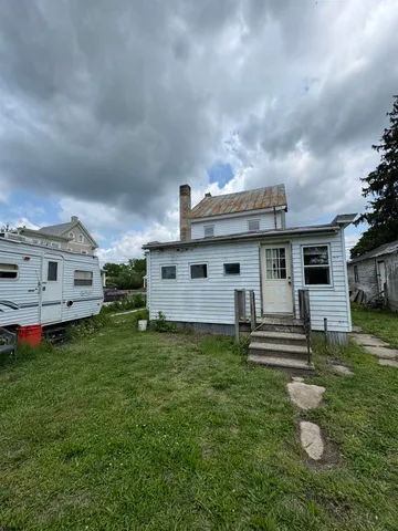 a view of a house with a yard and garage
