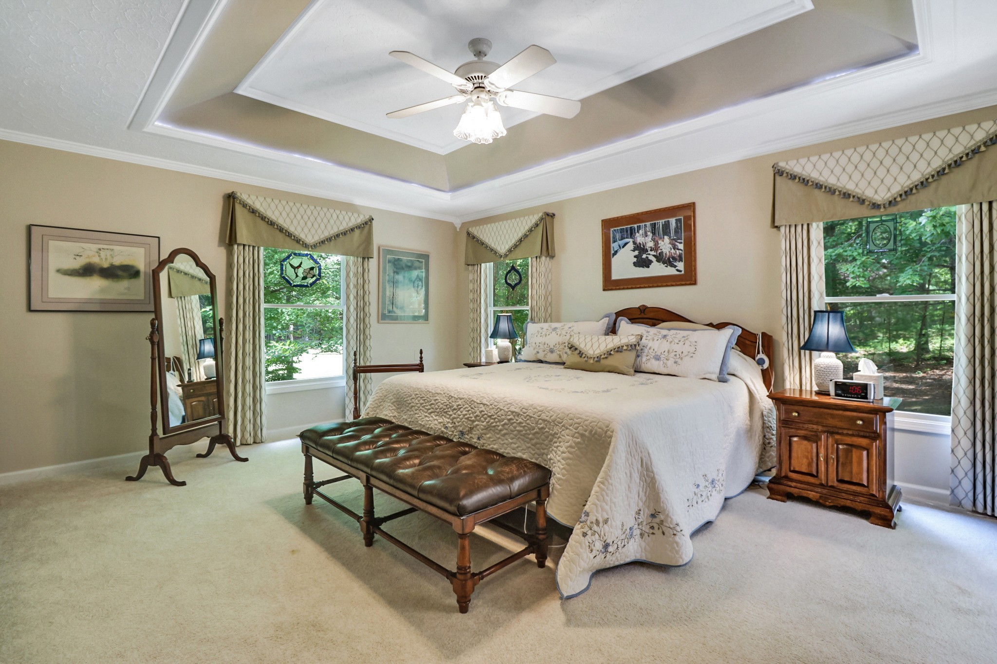 44 Inwood Court Crossville, TN 38558 - Photo 19 of 54 a spacious bedroom with a bed a chandelier and a large window