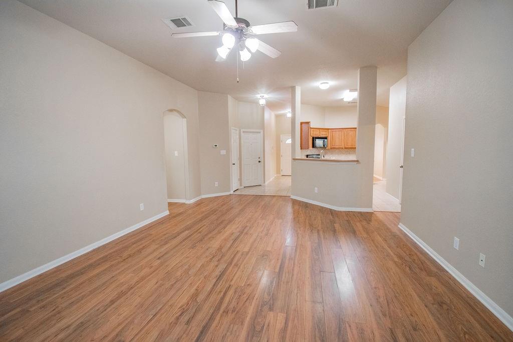 312 Pheasant Ridge Drive Round Rock, TX 78665 - Photo 4 of 34 Natural wood flooring complements the home's neutral palette, fostering an open and inviting atmosphere.