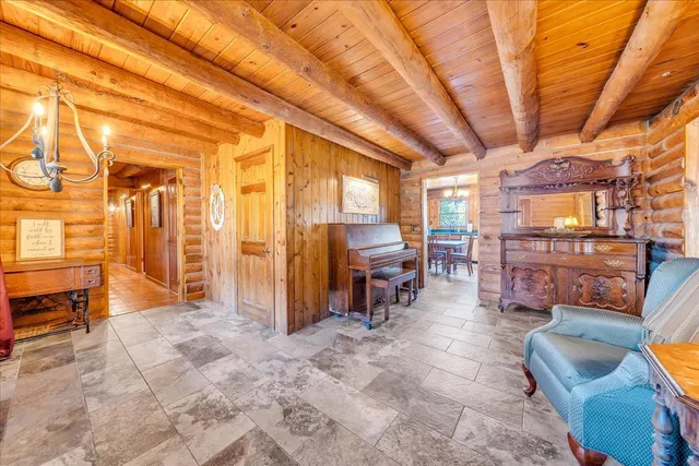 a view of a patio with a table and chairs and couches with wooden floor