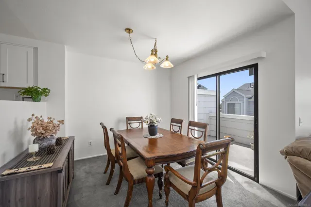 a view of a dining room with furniture wooden floor and a chandelier