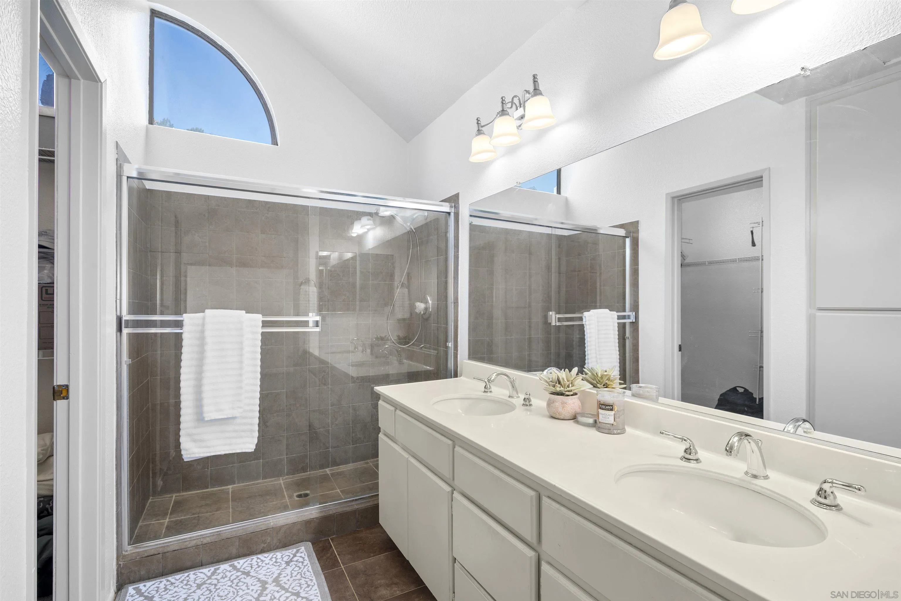 11061 Scripps Ranch Boulevard San Diego, CA 92131 - Photo 19 of 66 a bathroom with a double vanity sink mirror and shower
