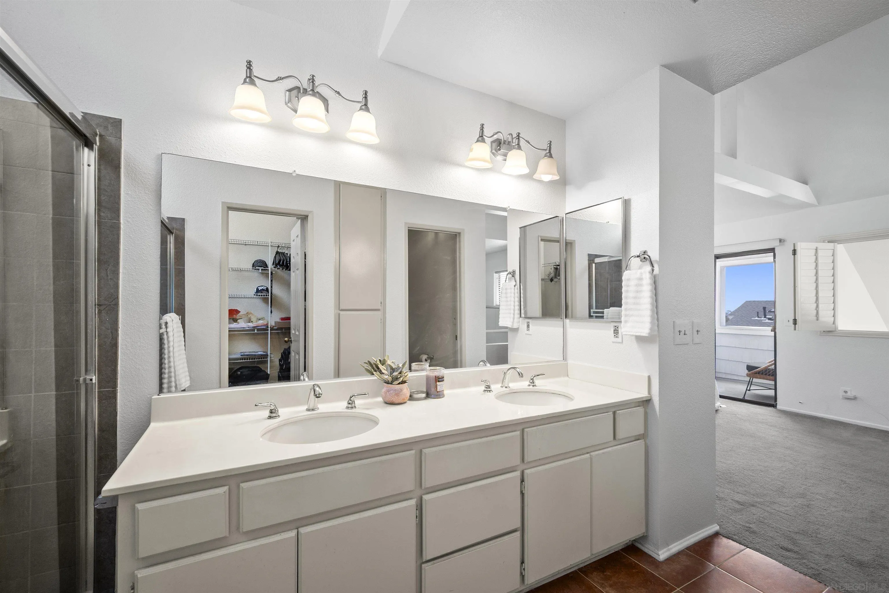 11061 Scripps Ranch Boulevard San Diego, CA 92131 - Photo 20 of 66 a bathroom with double vanity sinks and a mirror