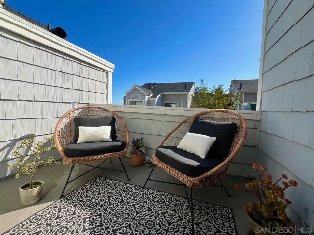 a view of a door and chair and table in front of house
