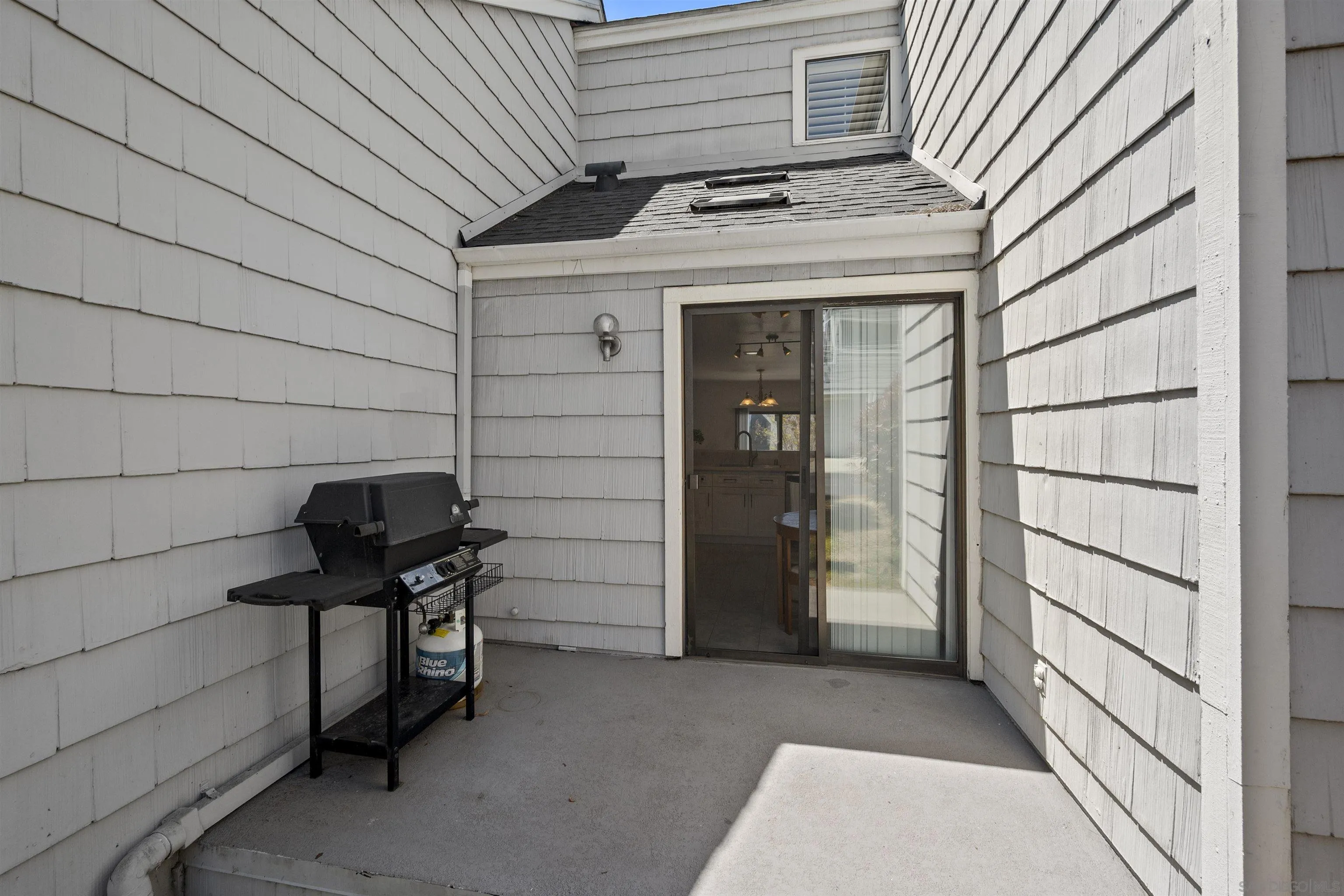 11061 Scripps Ranch Boulevard San Diego, CA 92131 - Photo 28 of 66 a view of a door and chair and table in front of house