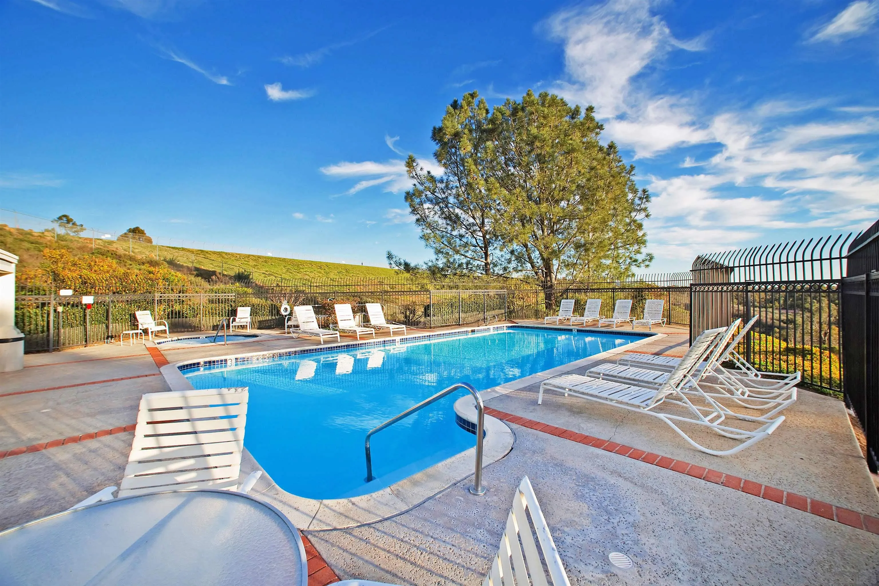 11061 Scripps Ranch Boulevard San Diego, CA 92131 - Photo 44 of 66 a view of a swimming pool with a lounge chair