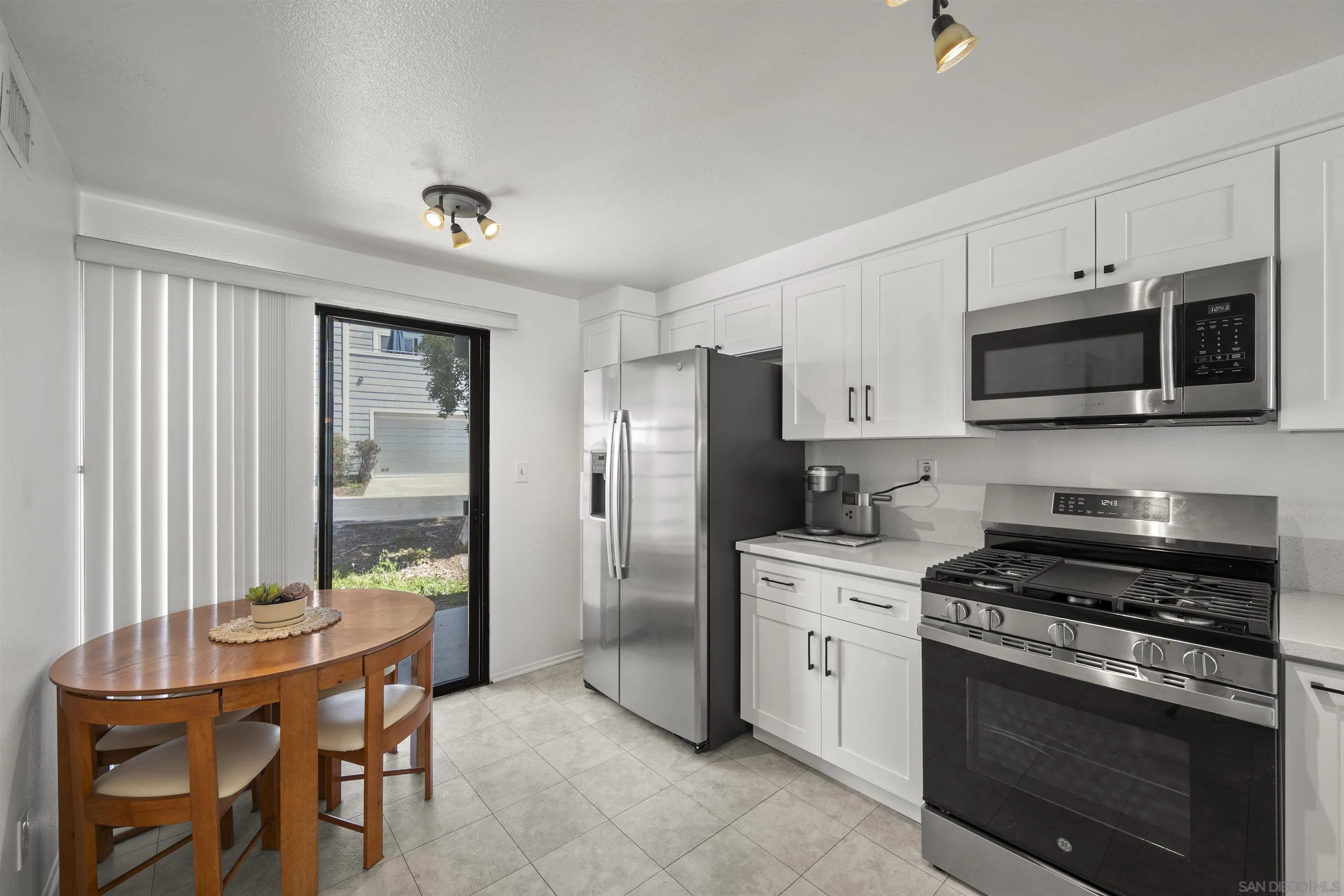 11061 Scripps Ranch Boulevard San Diego, CA 92131 - Photo 5 of 66 a kitchen with a stove a sink and a refrigerator