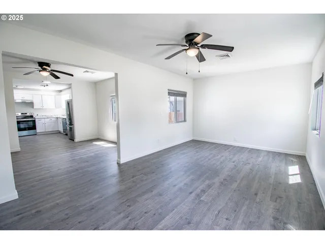 a view of an empty room and wooden floor