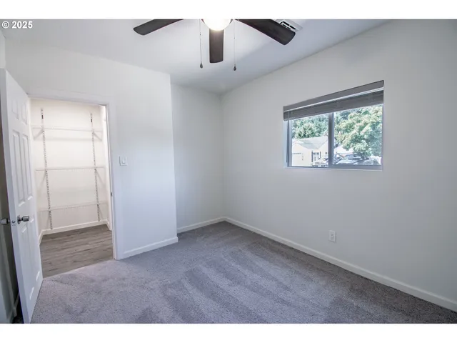 an empty room with windows and closet