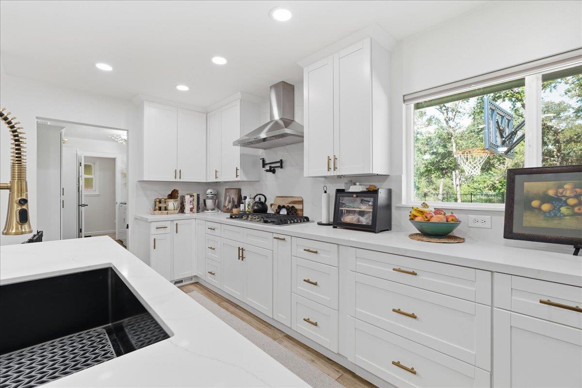4849 Alexon Way Carmichael, CA 95608 - Photo 17 of 50 a kitchen with white cabinets and window