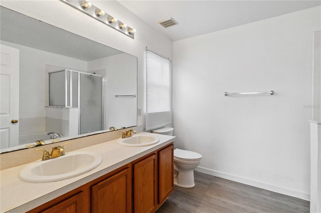 2881 Lyndscape Street Orlando, FL 32833 - Photo 14 of 30 a bathroom with a sink and a mirror