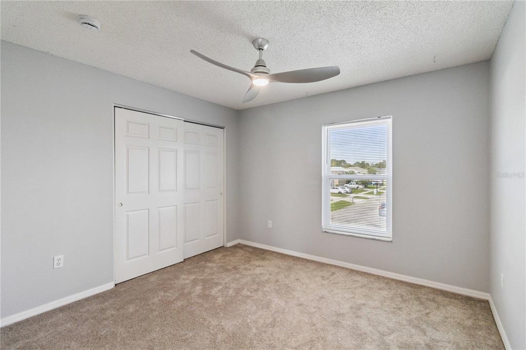 2881 Lyndscape Street Orlando, FL 32833 - Photo 17 of 30 an empty room with windows and ceiling fan