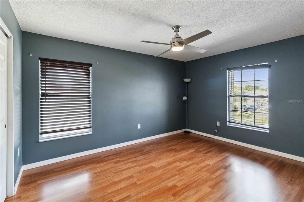 2881 Lyndscape Street Orlando, FL 32833 - Photo 18 of 30 a view of an empty room with wooden floor and a window