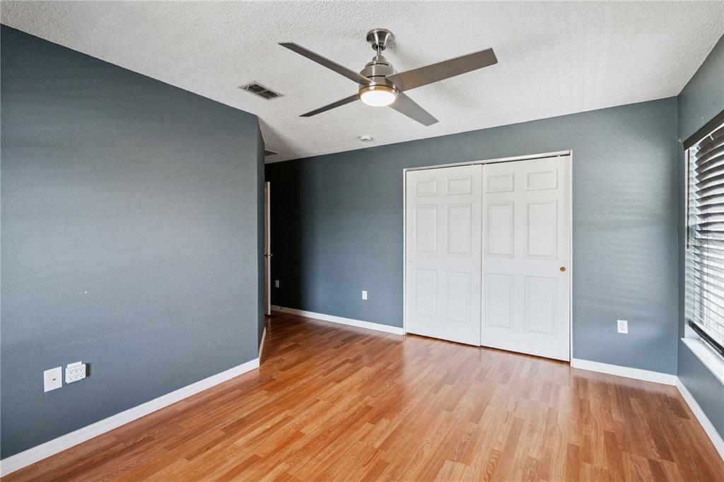 2881 Lyndscape Street Orlando, FL 32833 - Photo 19 of 30 wooden floor in an empty room with a window