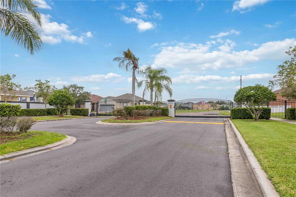 2881 Lyndscape Street Orlando, FL 32833 - Photo 25 of 30 a view of a house with a big yard and palm trees
