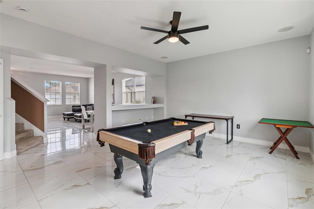 2881 Lyndscape Street Orlando, FL 32833 - Photo 5 of 30 a living room with furniture a rug and a window