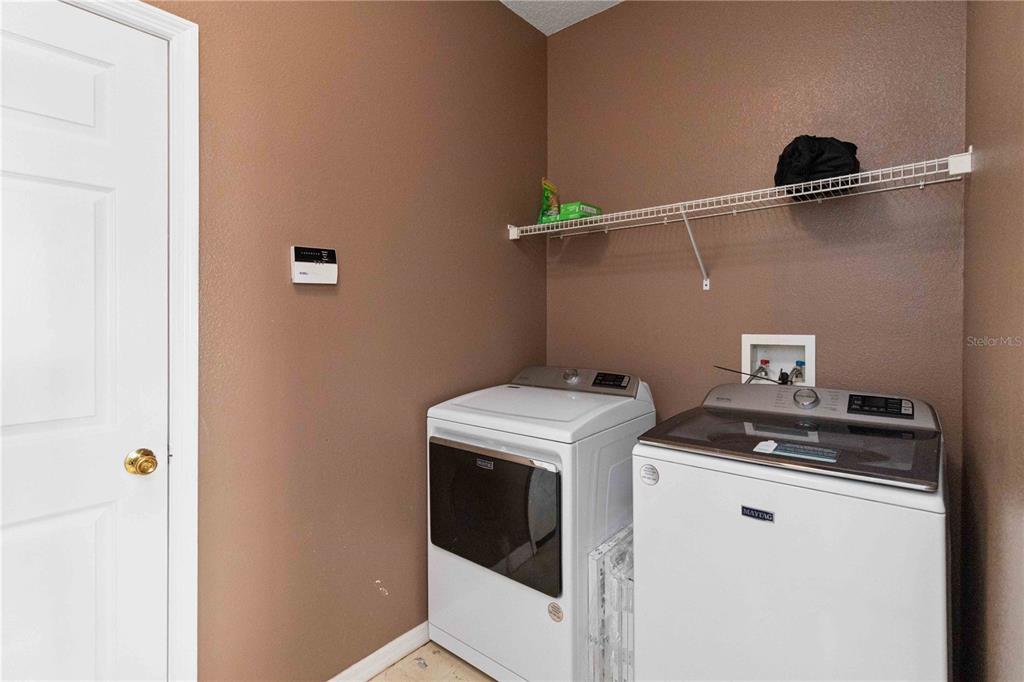 2881 Lyndscape Street Orlando, FL 32833 - Photo 8 of 30 a utility room with dryer and washer