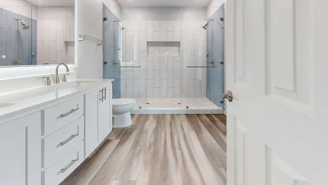 a bathroom with a sink a toilet and shower