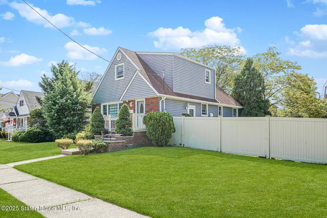 a view of backyard of house with green space