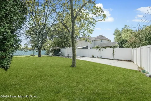 a view of empty room with wooden floor and window