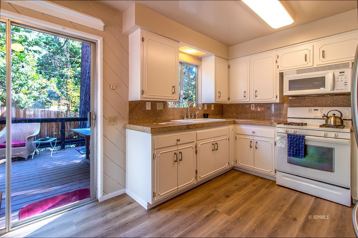 54789 Daryll Road Idyllwild, CA 92549 - Photo 18 of 44 a kitchen with a sink cabinets wooden floor and appliances