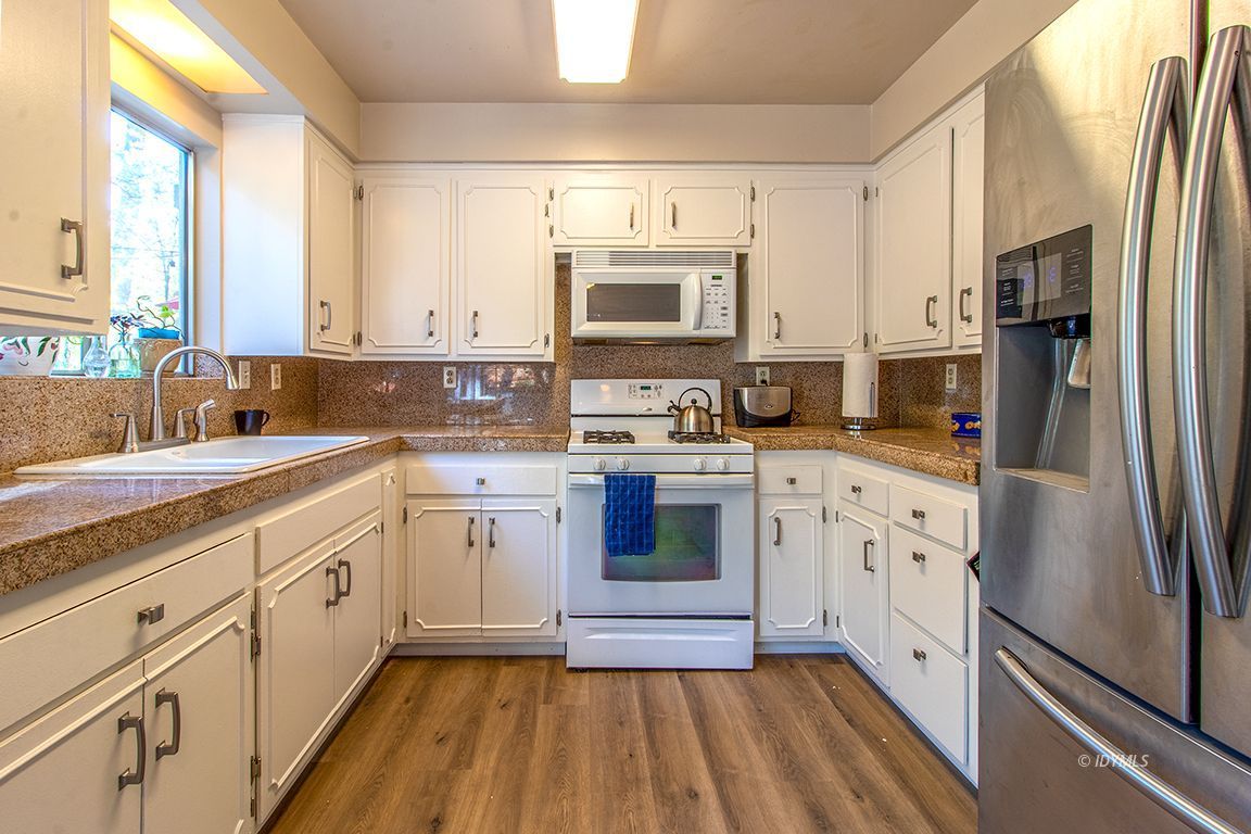 54789 Daryll Road Idyllwild, CA 92549 - Photo 20 of 44 a kitchen with white cabinets sink and stainless steel appliances