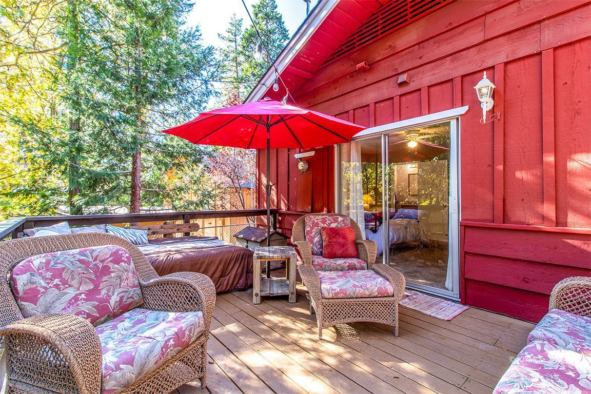 54789 Daryll Road Idyllwild, CA 92549 - Photo 40 of 44 a balcony with furniture and red umbrella