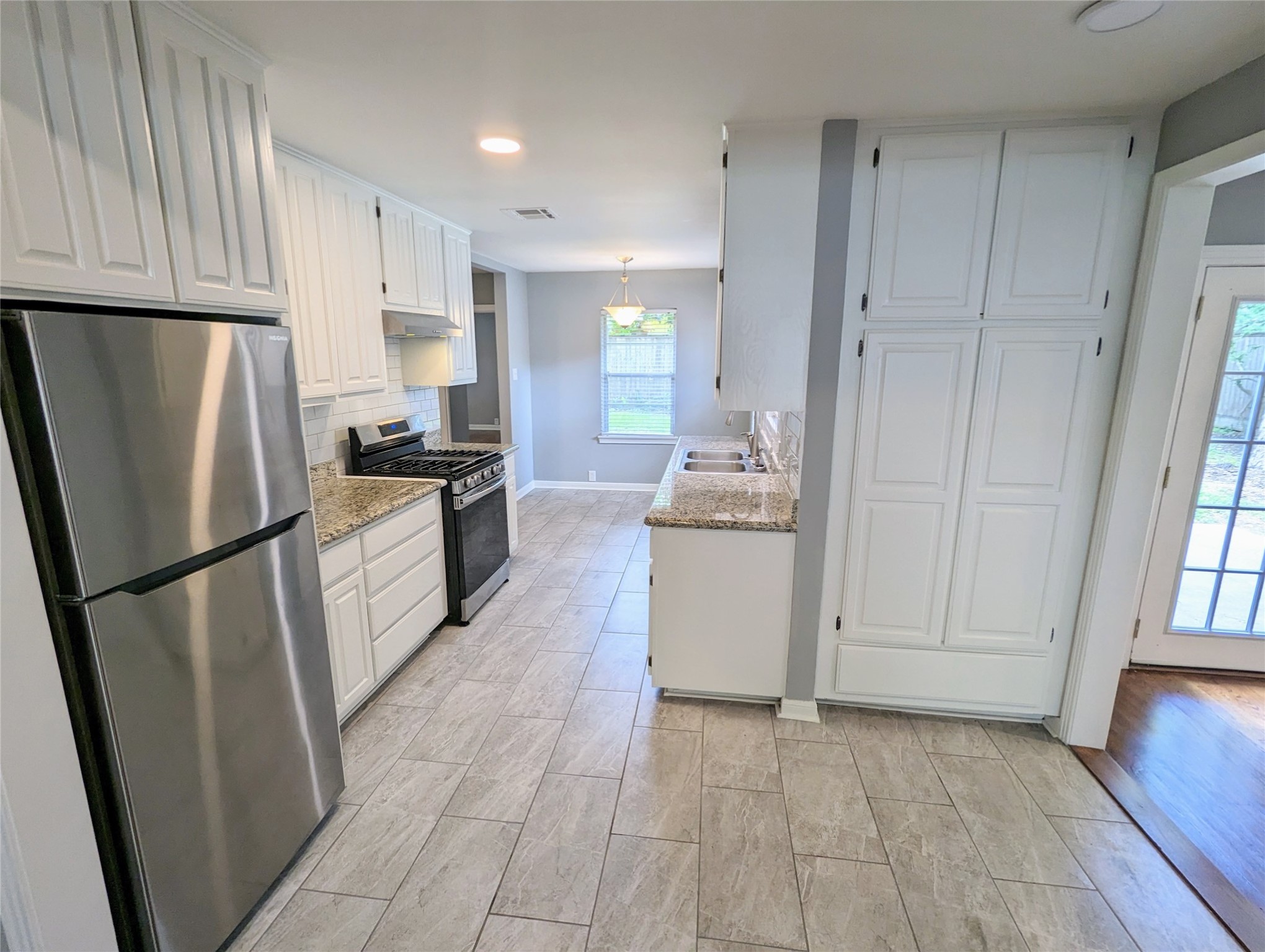 3111 Deal Street Houston, TX 77025 - Photo 13 of 39 a kitchen with a refrigerator a stove top oven and cabinets