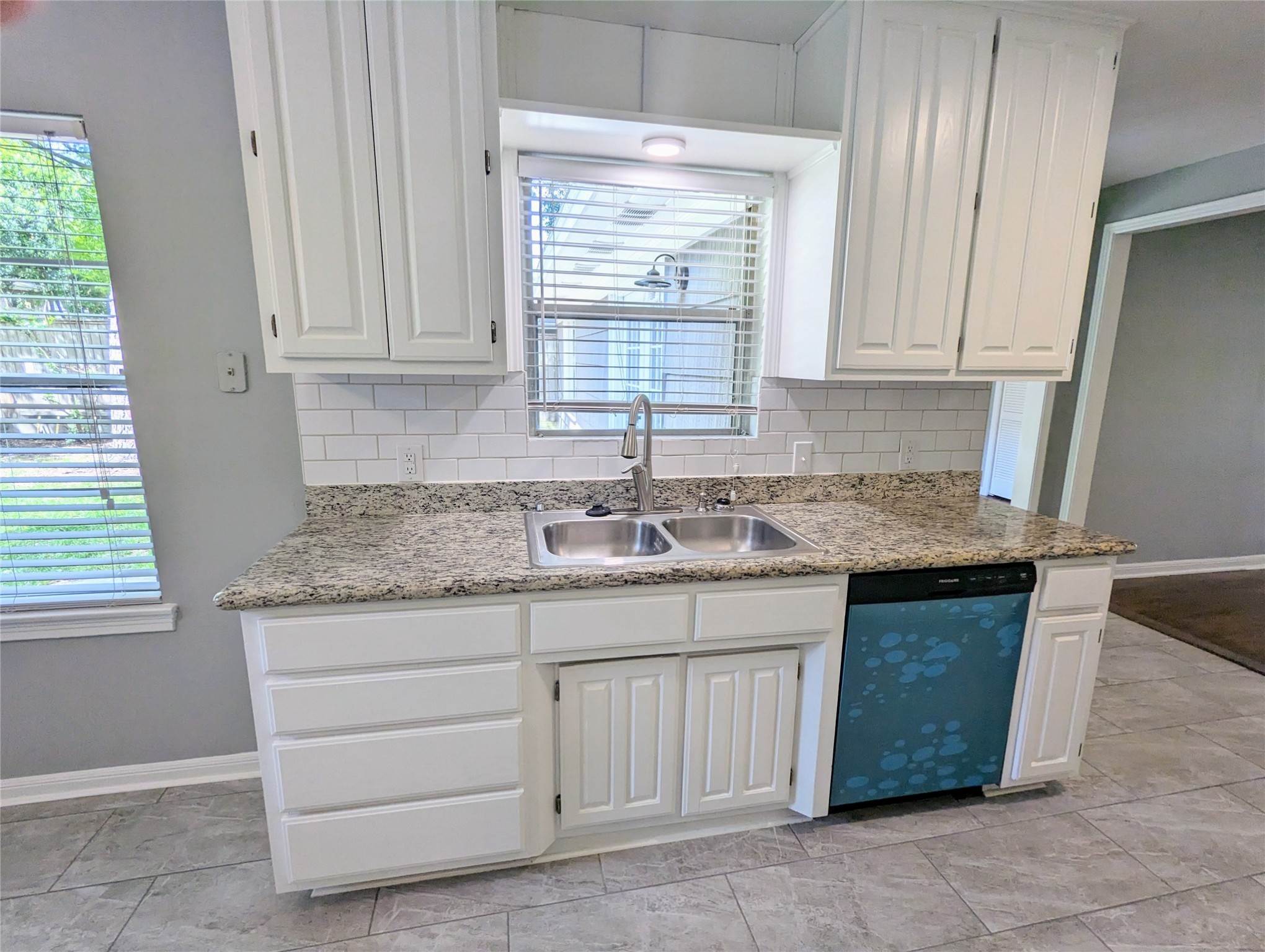 3111 Deal Street Houston, TX 77025 - Photo 16 of 39 a kitchen with granite countertop a sink cabinets and a window