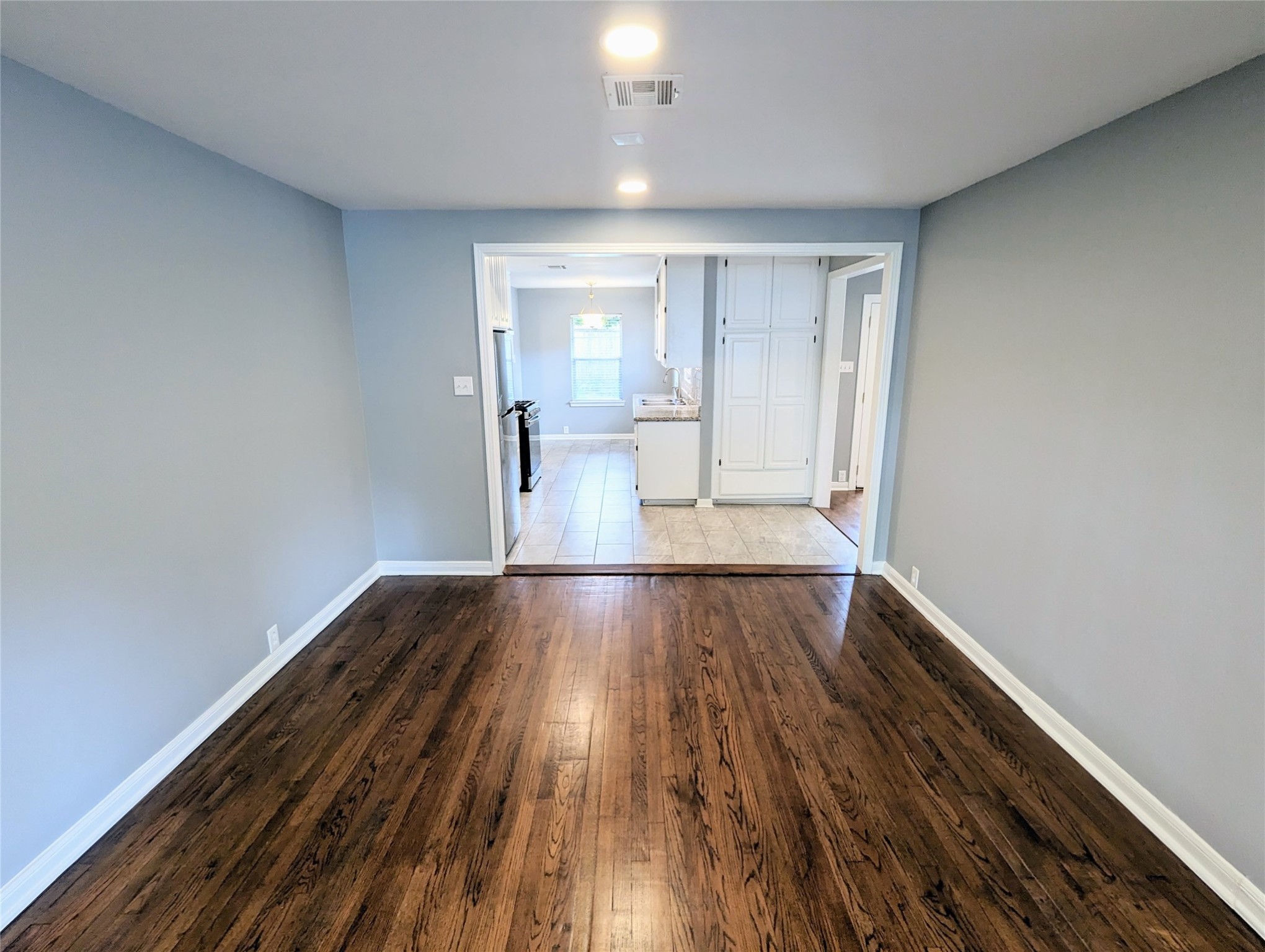 3111 Deal Street Houston, TX 77025 - Photo 10 of 39 a view of an empty room and wooden floor
