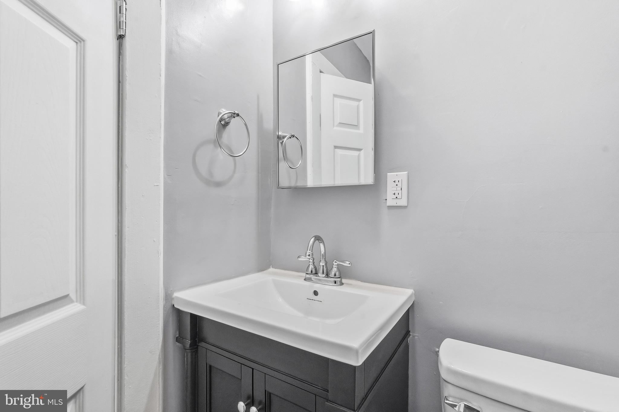 21-23 Harding Avenue Pennsville, NJ 08070 - Photo 12 of 35 a bathroom with a sink toilet and mirror