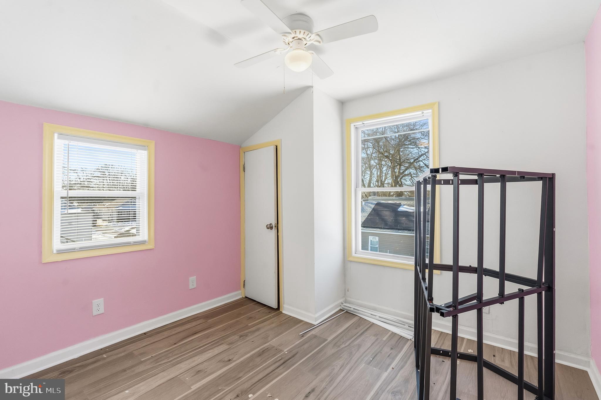 21-23 Harding Avenue Pennsville, NJ 08070 - Photo 13 of 35 a view of an empty room with window wooden floor and a kitchen