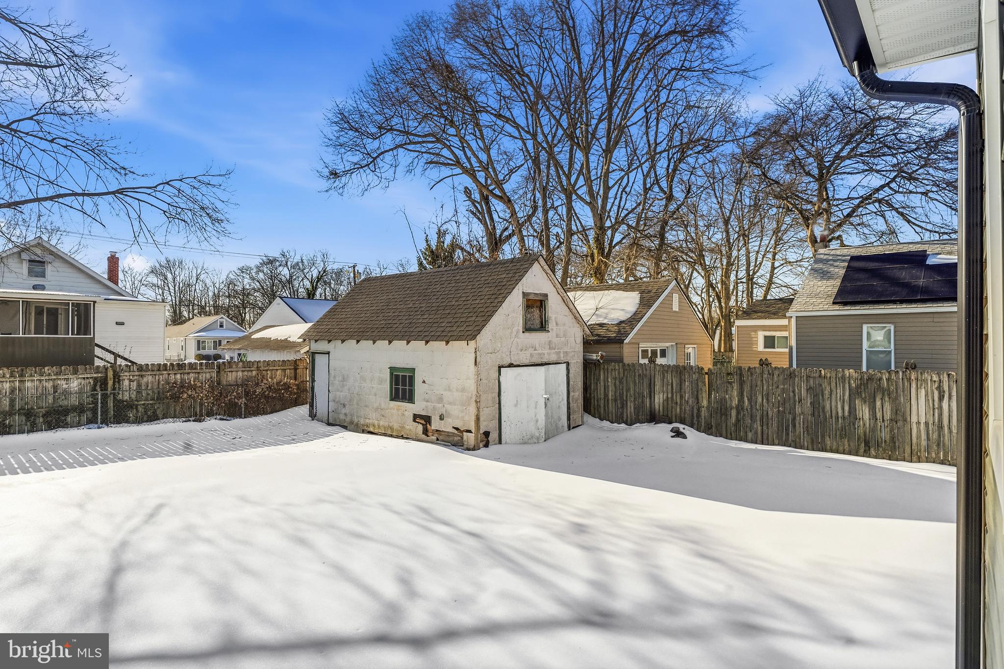 21-23 Harding Avenue Pennsville, NJ 08070 - Photo 33 of 35 a view of a house with a yard covered in snow