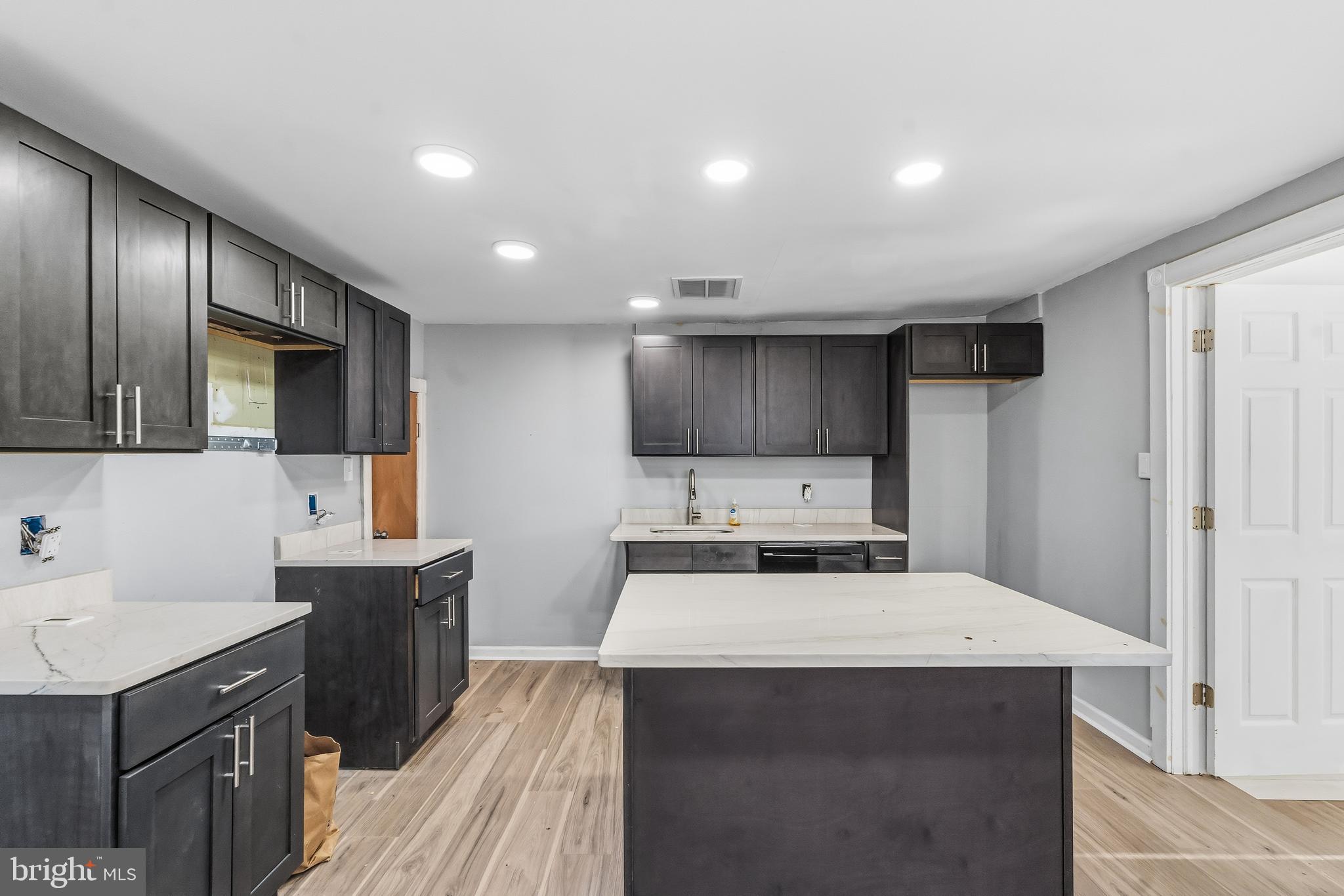 21-23 Harding Avenue Pennsville, NJ 08070 - Photo 6 of 35 a kitchen with a sink a stove and cabinets