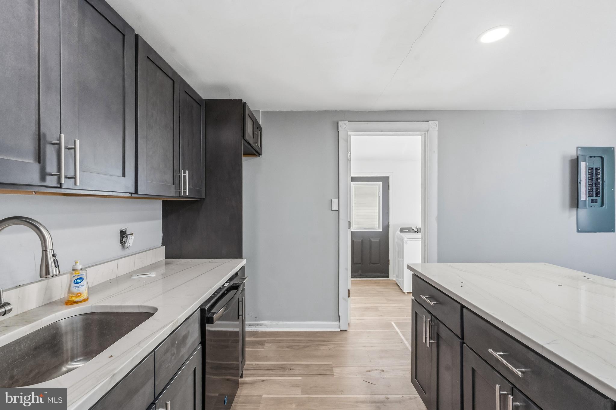 21-23 Harding Avenue Pennsville, NJ 08070 - Photo 10 of 35 a kitchen with stainless steel appliances granite countertop a sink and a refrigerator