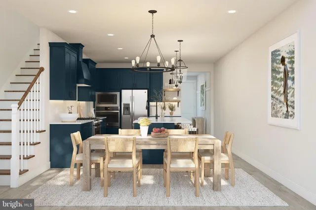 a dining room with furniture a chandelier and kitchen view