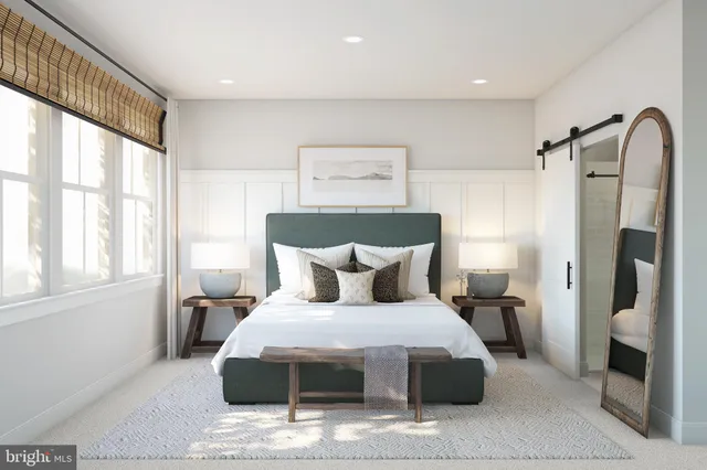 a bedroom with a large bed and a window